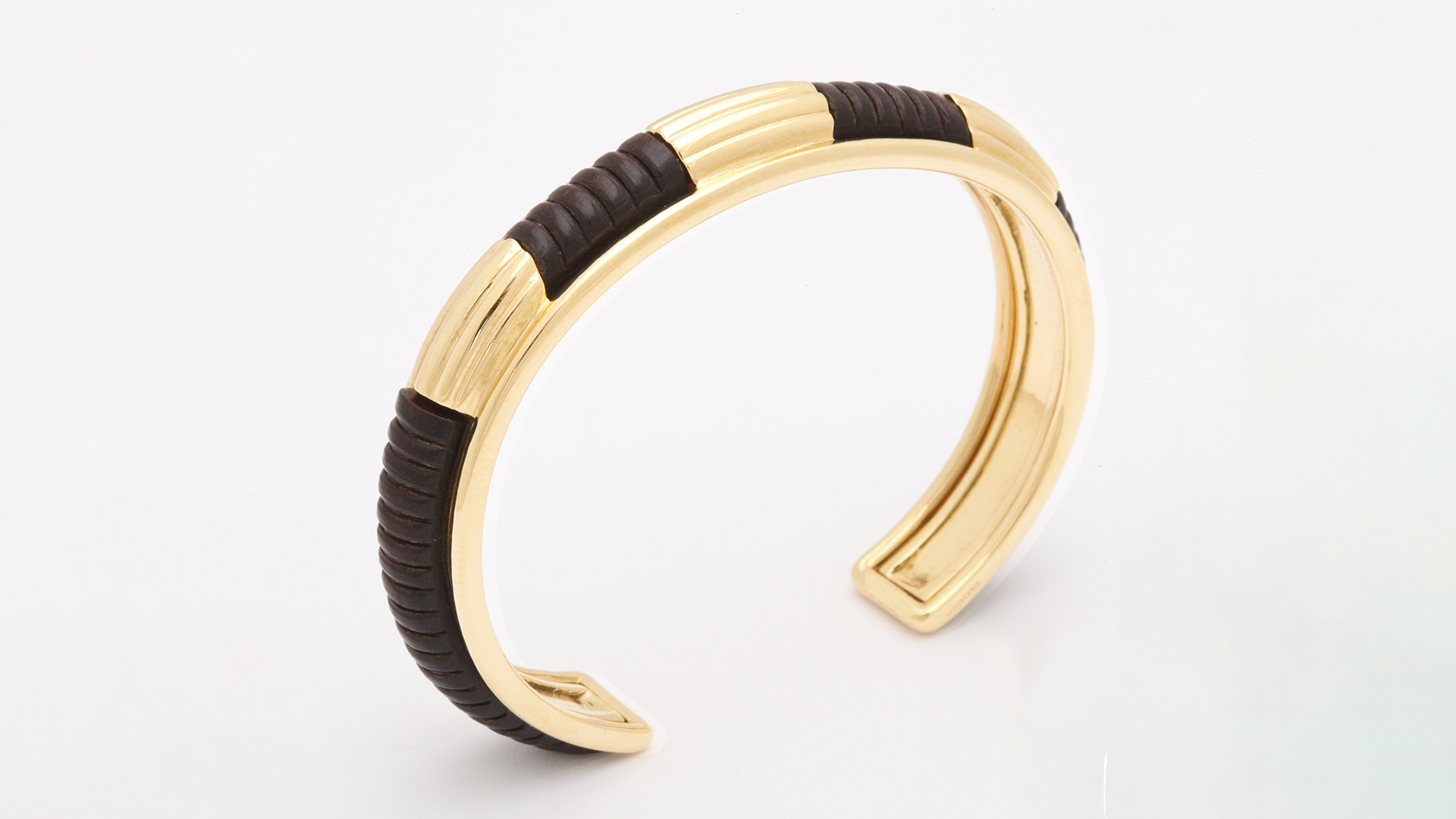 Wood and 18-karat gold cuff, signed Boucheron, 1970s, courtesy Pat Saling (@patsaling).