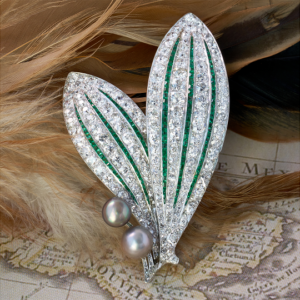 Art Deco diamond, emerald, natural pearl and platinum brooch, courtesy JS Fearnley (@jsfearnley).