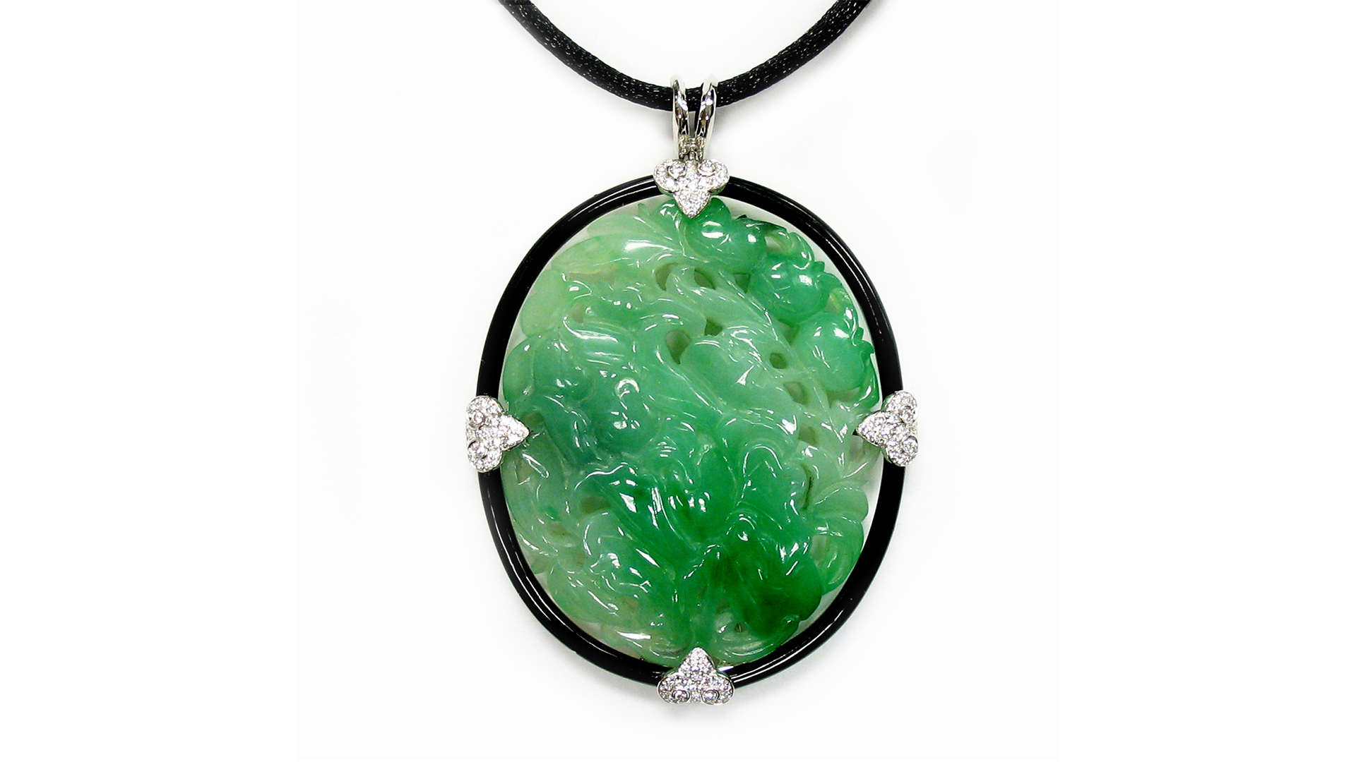 Carved natural jadeite, diamond, onyx and 18-karat white gold floral motif pendant, courtesy, J.&S.S. DeYoung (@laurendeyoungjewelry).